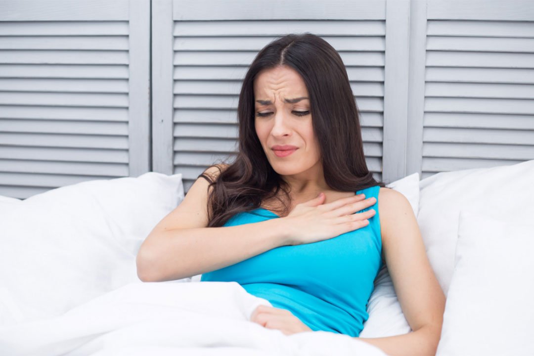 Woman pausing during an everyday discomfort moment